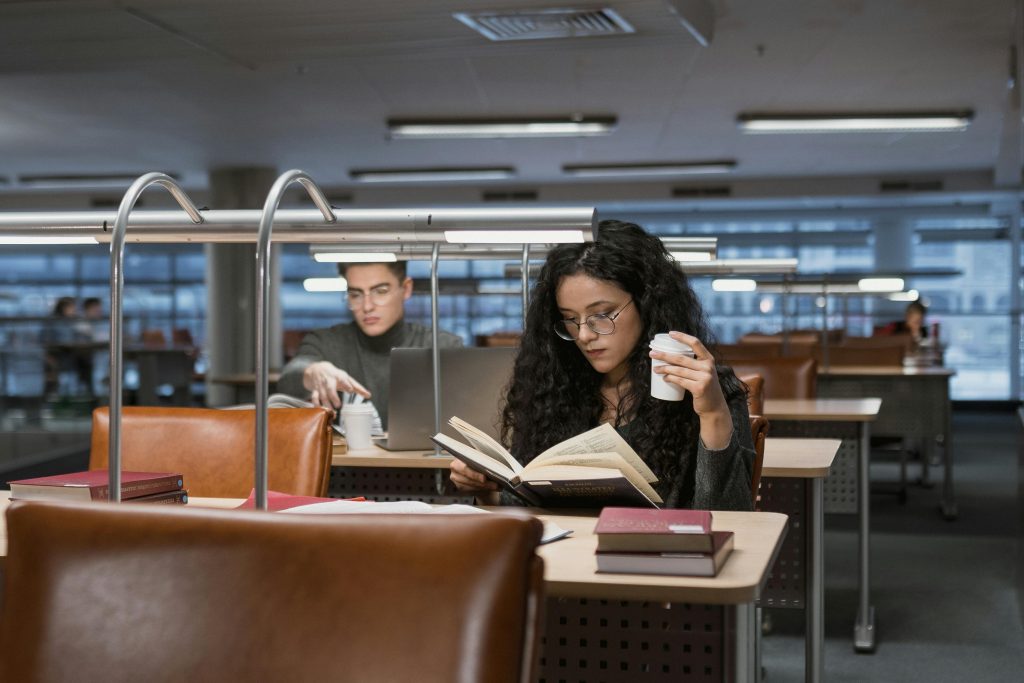 college student researches in library