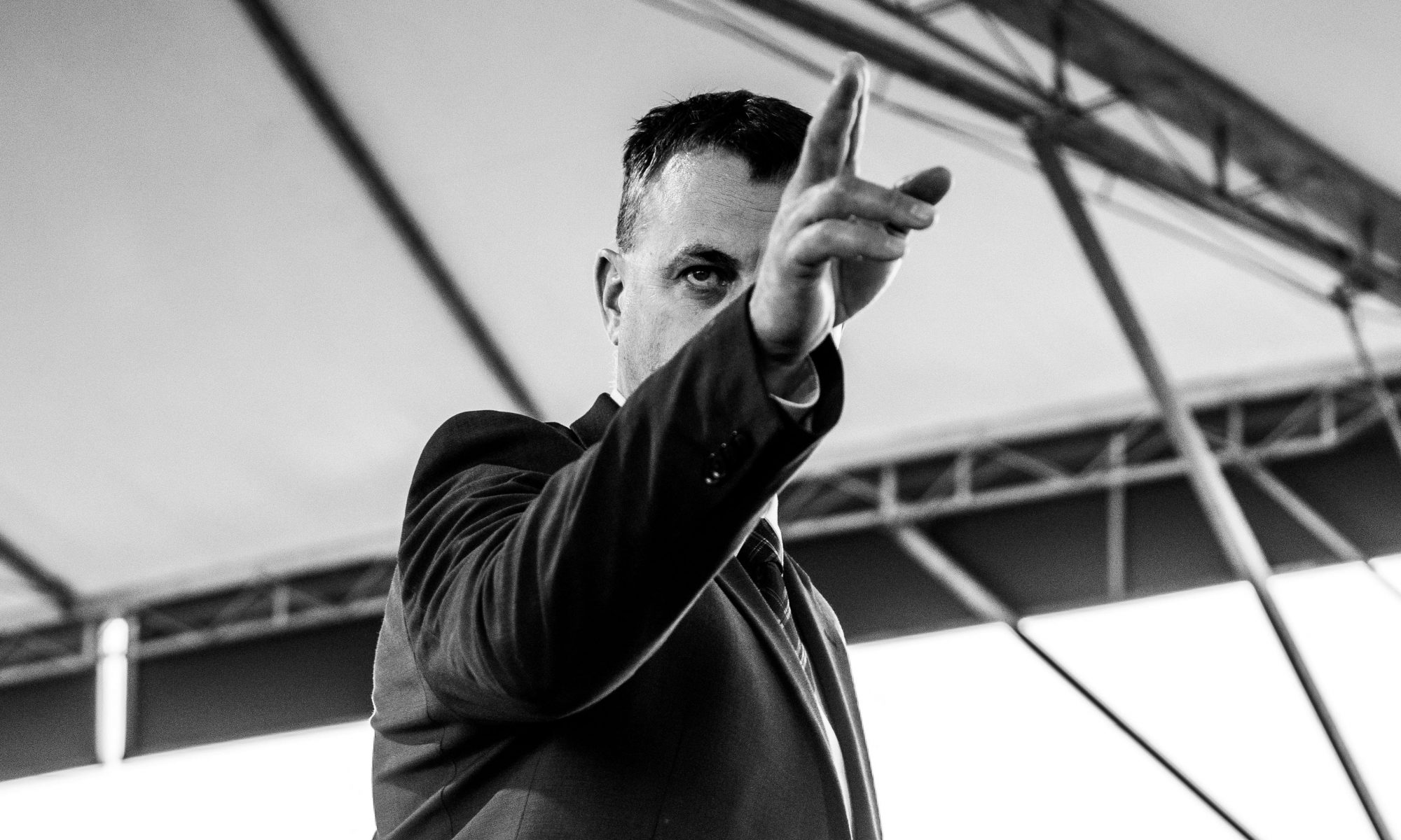 a motivational speaker points to the crowd