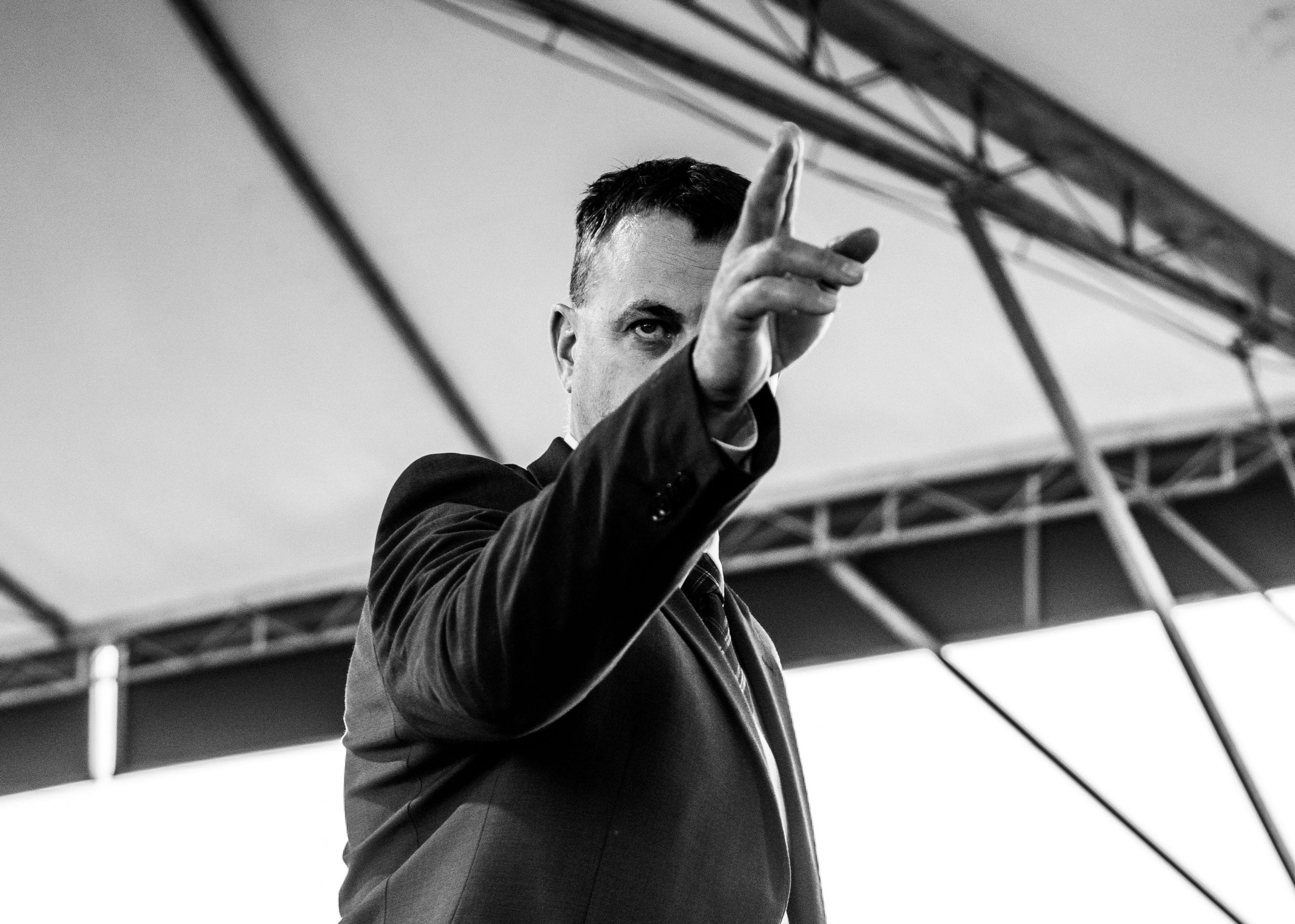 a motivational speaker points to the crowd