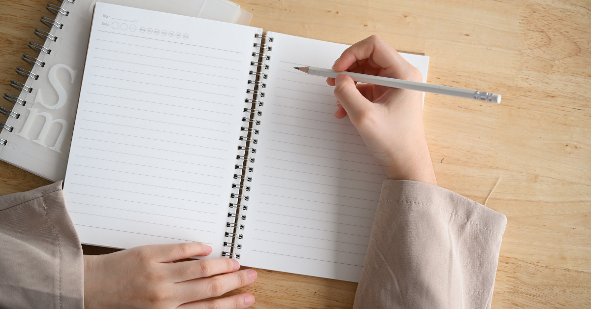 Someone starting to write on a blank page